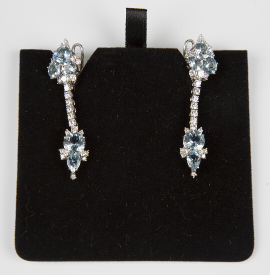 A pair of platinum, aquamarine and diamond pendant earrings, each surmount claw set with three circu