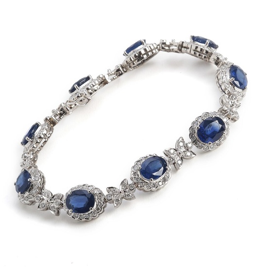 A sapphire and diamond bracelet set with numerous oval-cut sapphires and brilliant-cut...