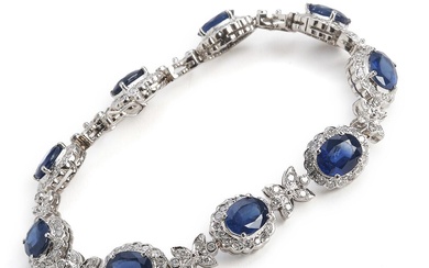 A sapphire and diamond bracelet set with numerous oval-cut sapphires and brilliant-cut...
