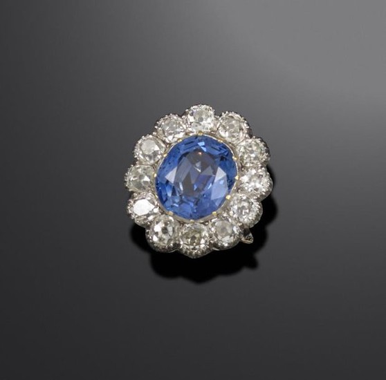 A sapphire and diamond cluster ring, the oval-shaped...