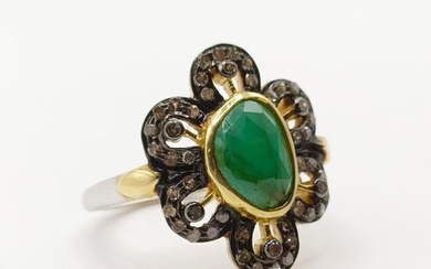 A silver-gilt ring, set with ovoid emerald and diamonds, mix...