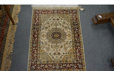 A small Persian style part silk rug, cream ground with flora...