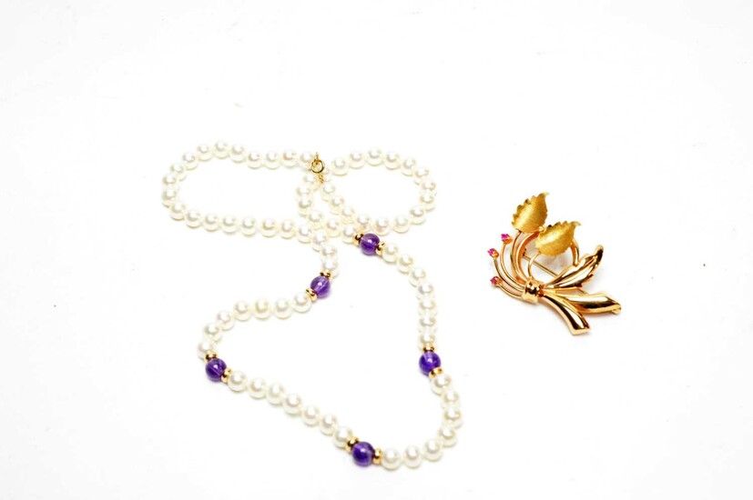 A yellow-metal flower pattern brooch and an amethyst and pearl necklace