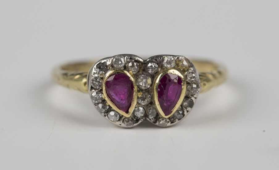An 18ct gold, ruby and diamond twin cluster ring, each cluster mounted with a pear shaped ruby withi