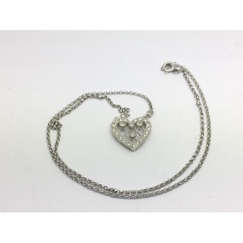 An 18ct white gold diamond set heart shaped pendant on chain...