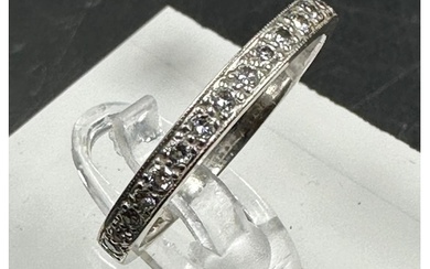 An 18ct white gold wedding band with diamonds, approximately...