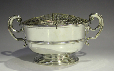 An Edwardian silver rose bowl, the slightly tapered circular girdled body flanked by two flying scro