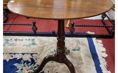 An early 19th Century Mahogany oval Supper Table on tripod s...