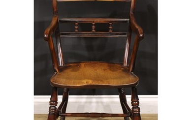 An early 19th century yew and elm elbow chair, saddle seat, ...