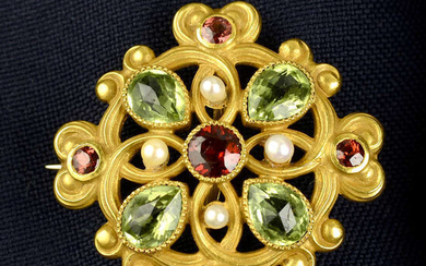 An early 20th century lightly textured 14ct gold garnet, peridot and seed pearl brooch.