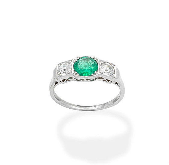 An emerald and diamond three-stone ring