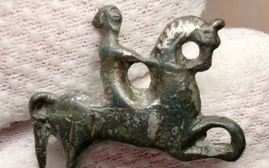 Ancient Roman Bronze Cavalry Brooch fibula of an Equestrian galloping right. Traces of silver on the surface.