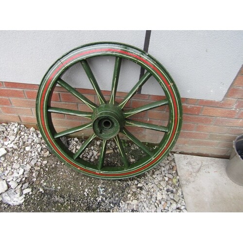 Antique wooden wheel wooden so]pokes with steel tread painte...