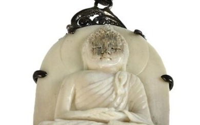Asian carving - A carved piece of mammoth, a Buddha, framed as a pendant and with 3 facet polished tourmalines.