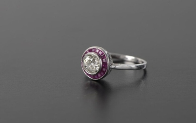 Ring in platinum 850 thousandths set with an old cut diamond of about 0.8 ct in a setting of nineteen calibrated rubies.