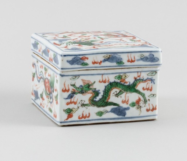 CHINESE WUCAI PORCELAIN SQUARE COVERED BOX Decoration of a dragon and phoenix chasing a fiery pearl. Six-character Kangxi mark on ba...