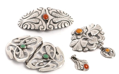 Cohr a.o.: A Danish silver brooch, two belt buckles and two pendants, set with cabochon-cut amber and chrysoprase. L. 3.8–9.2 cm. Circa 1910–30. (5)
