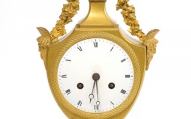 Directoire clock called "Urn" in gilt bronze surmounted by a "Vase of flowers". French work. Period: end of XVIIIth century. Wire movement. (Missing pendulum, small * to the dial and small ** to a bronze). H.:+/-38,5cm.