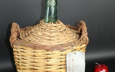 French demi john bottle in wicker basket