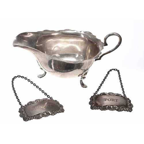George V silver cream jug, with shaped cut rim and raised on...