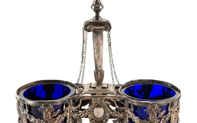 LOUIS XVI SILVER DOUBLE-SALT CELLAR Maker's mark rubbed. Central chained pedestal above frames with neoclassical motifs. Oval cobalt..