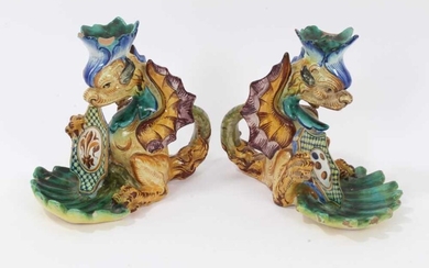 Pair of Cantagalli maiolica candlesticks, in the form of heraldic dragons with scallop shell bowls, cockerel marks, 15.5cm height