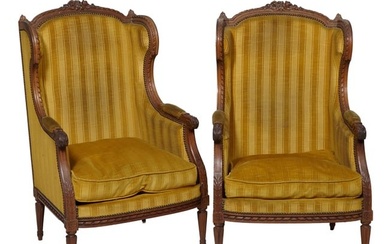 Pair of French Louis XVI Style Carved Walnut Wing Chairs, 19th c., floral carved crest, finialed