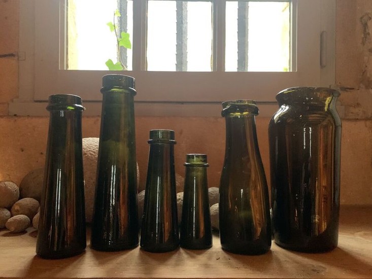 Six dark green glass truffle jars. 19th century...
