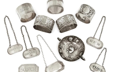 Six silver decanter labels including two oval George III examples, London, 1807, Thomas Phipps & Edward Robinson, one reading 'Brandy', the other 'Rum'; one label ('Scotch') with chain deficient; together with a small silver dish with import marks...