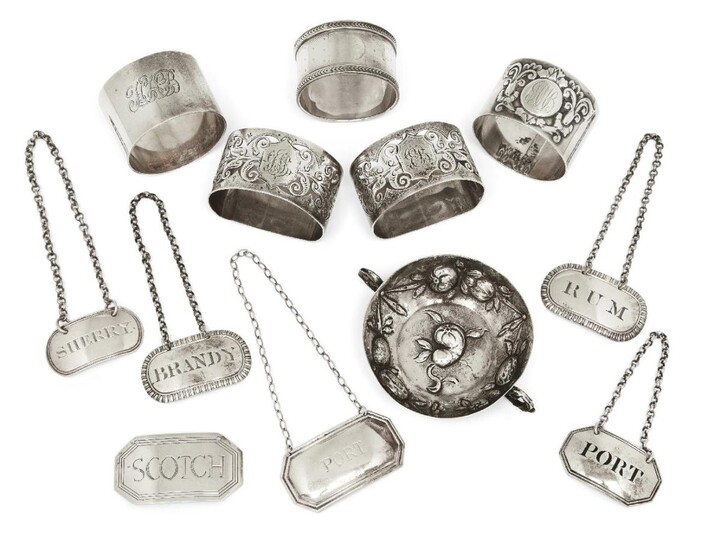 Six silver decanter labels including two oval George III examples, London, 1807, Thomas Phipps & Edward Robinson, one reading 'Brandy', the other 'Rum'; one label ('Scotch') with chain deficient; together with a small silver dish with import marks...