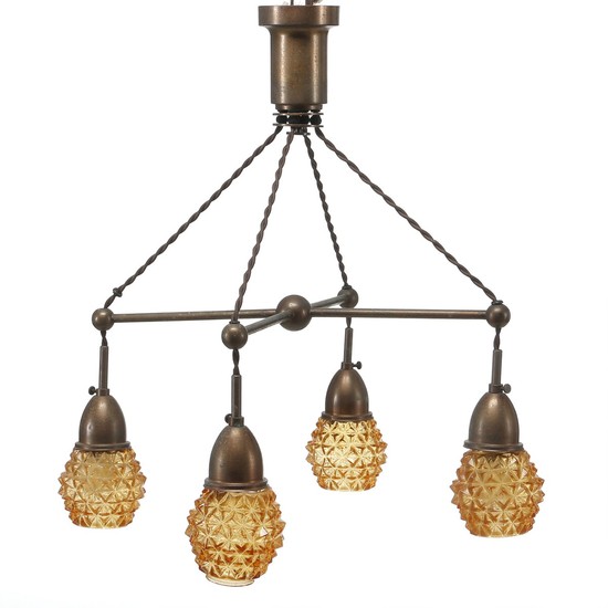 Unknown designer: Art Deco chandelier og patinated, browned brass. Four arms with amber coloured glass shades. Made 1920–1930's.