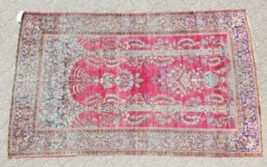 AN ANTIQUE PERSIAN KASHAN SILK RUG with floral design