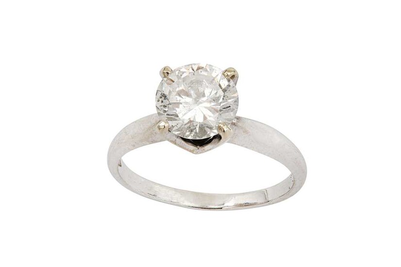 A diamond single-stone ring The brilliant-cut diamond in a...