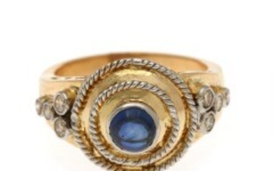 1927/1126 - A diamond ring set with a blue synthetic cabochon sapphire flanked by eight brilliant-cut diamonds, mounted in 18k gold. Size 58.