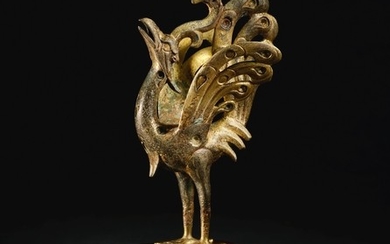 A SPLENDID AND RARE GOLD AND SILVER-INLAID PARCEL-GILT BRONZE FIGURE OF A PEACOCK HAN DYNASTY