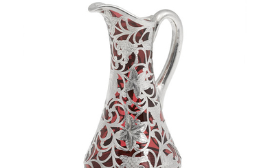 An American glass pitcher with silver overlay