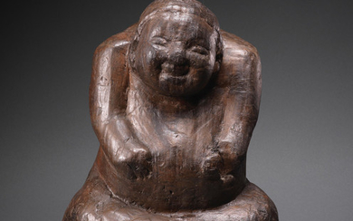 A very rare carved wood seated figure