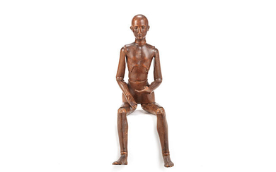 A late 19th / early 20th century Continental carved and stained wood artists lay figure