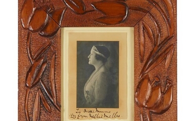 A CARVED KAURI PINE FRAME WITH AN AUTOGRAPHED PHOTO OF DAME NELLIE MELBA