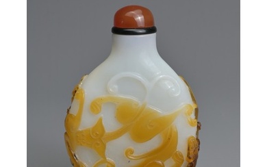 A CHINESE AMBER OVERLAY GLASS SNUFF BOTTLE, QING DYNASTY. Of...