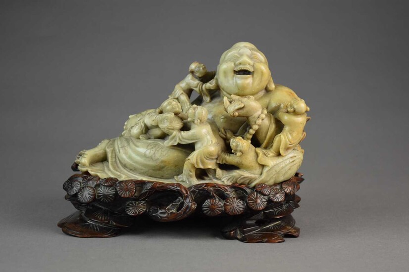 A Chinese carved soapstone figure of a laughing Buddha, Qing Dynasty