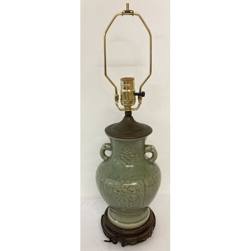 A Chinese celadon glazed, 2 handled lamp base with floral de...
