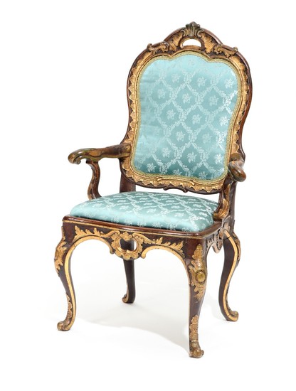 A Danish 18th century partly painted and gilded beech Rococo armchair, richly carved with rocailles and foliage.