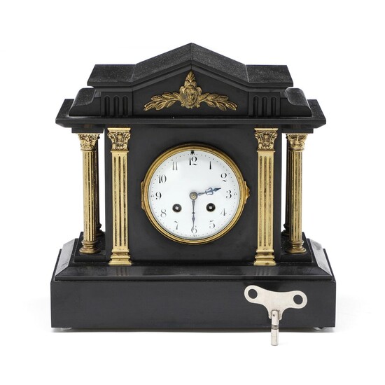 NOT SOLD. A French black marble clock, decorated with brass columns and pilastres, white enamel dial. Early 20th century. H. 30 cm. W. 32 cm. D. 15 cm. – Bruun Rasmussen Auctioneers of Fine Art