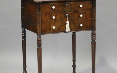 A George IV figured mahogany side table with projecting corners, the two drawers with bone handles a