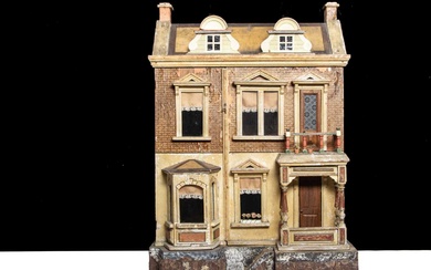 A Gottschalk wooden dolls’ house raised on a bark base