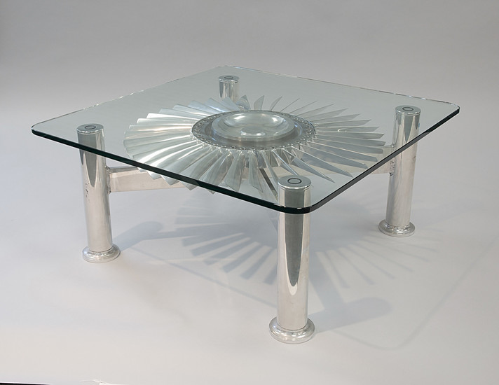 A MODERN STAINLESS STEEL AND GLASS TABLE FEATURING A JET ENGINE TURBINE, CIRCA 1960s