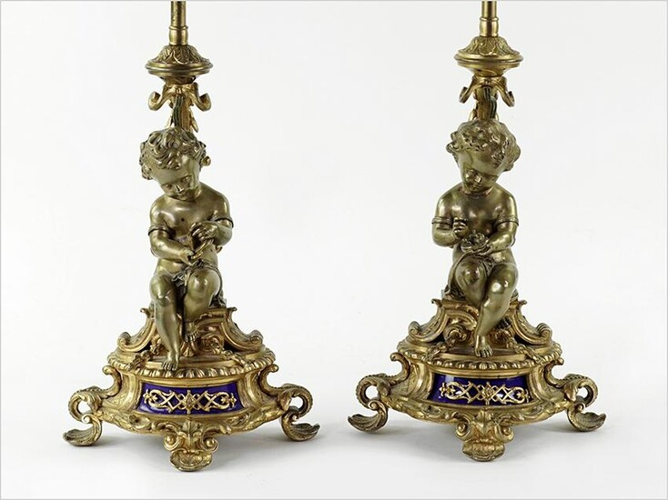 A Pair of Louis XV Style Gilt Bronze Cherub Form Lamps.