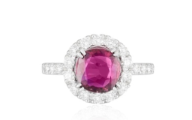 A RUBY AND DIAMOND DRESS RING The cushion-shaped ruby weigh...