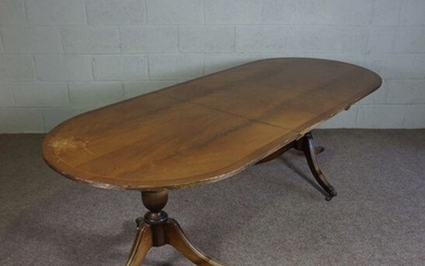 A Regency style mahogany veneered twin pillar extending dining table, with one additional leaf, 73cm